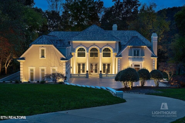 mediterranean / spanish-style home featuring a front yard