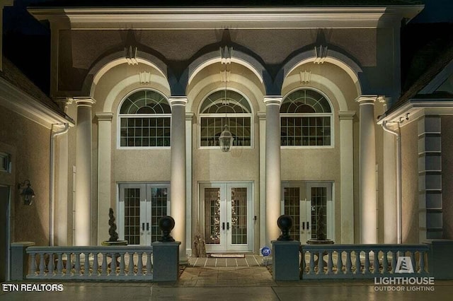 view of exterior entry featuring french doors