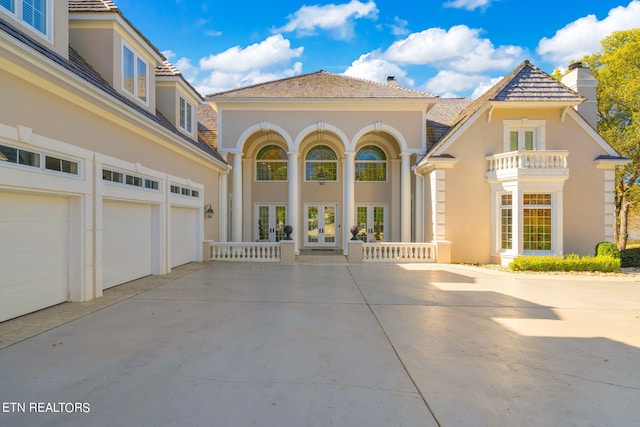 mediterranean / spanish home with french doors and a garage