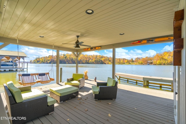 view of dock with a deck with water view and an outdoor living space