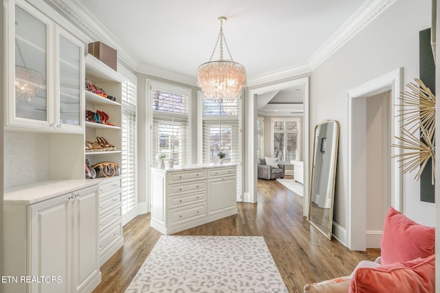 spacious closet featuring a chandelier and wood-type flooring