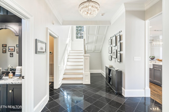 entrance foyer with ornamental molding and a chandelier