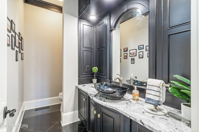 bathroom with vanity, toilet, and tile patterned floors