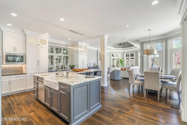 kitchen featuring sink, dark wood-type flooring, a wealth of natural light, and pendant lighting