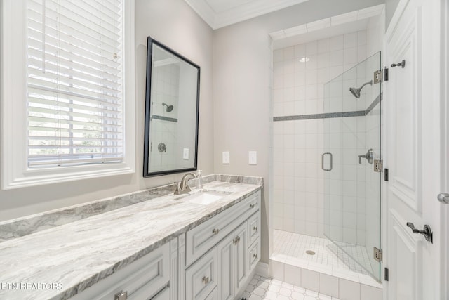 bathroom featuring vanity, crown molding, a shower with shower door, and tile patterned flooring