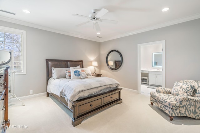 bedroom featuring crown molding, ensuite bath, light colored carpet, and ceiling fan