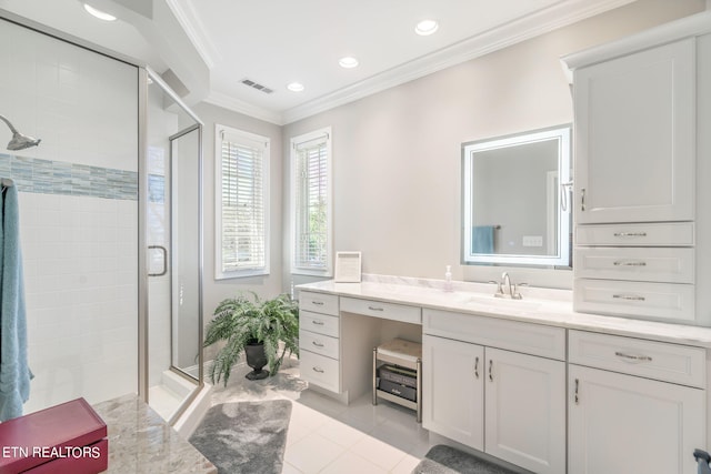 bathroom with a shower with door, vanity, ornamental molding, and tile patterned flooring