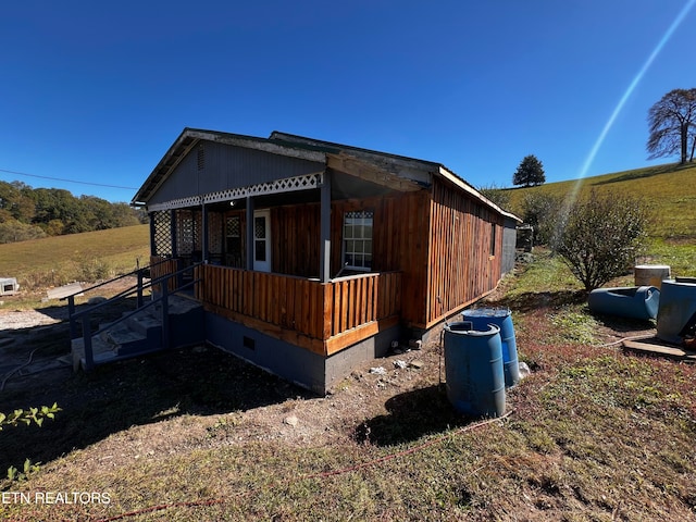 view of side of home featuring a porch