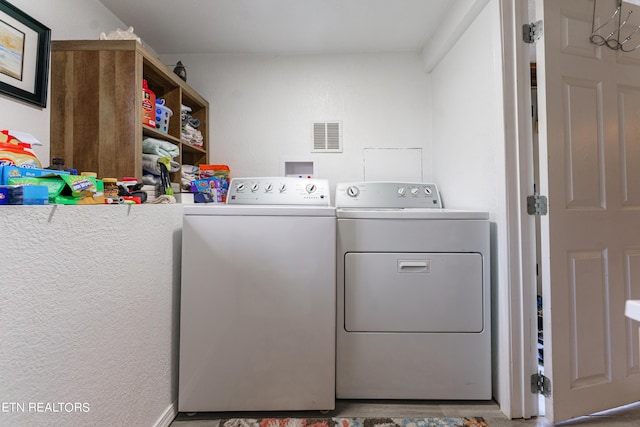 laundry room with washing machine and clothes dryer