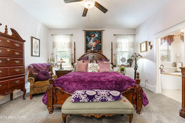 bedroom featuring ceiling fan, light carpet, and multiple windows