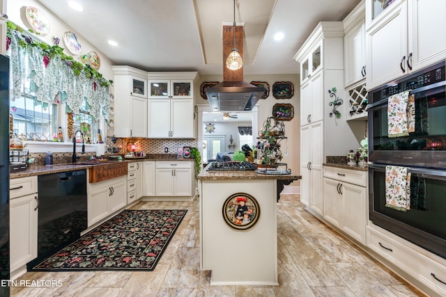 kitchen with a center island, black appliances, white cabinets, hanging light fixtures, and tasteful backsplash