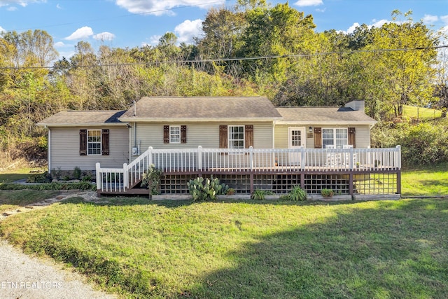 single story home featuring a front lawn and a deck