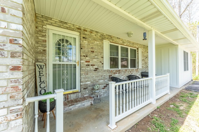 view of exterior entry featuring covered porch