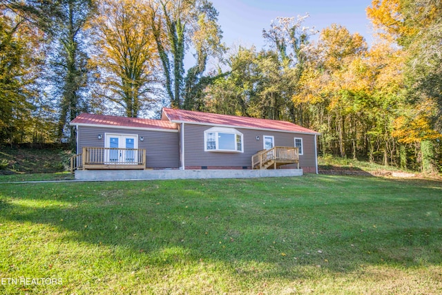 manufactured / mobile home with a front yard and a wooden deck