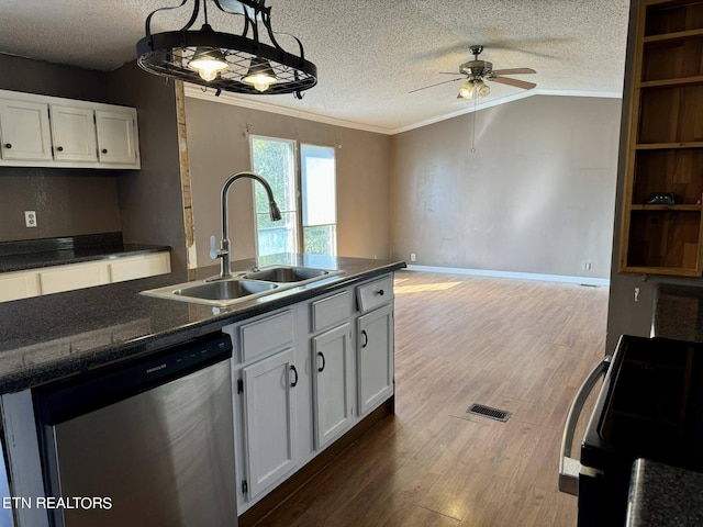 kitchen featuring sink, hanging light fixtures, hardwood / wood-style floors, stainless steel dishwasher, and white cabinets