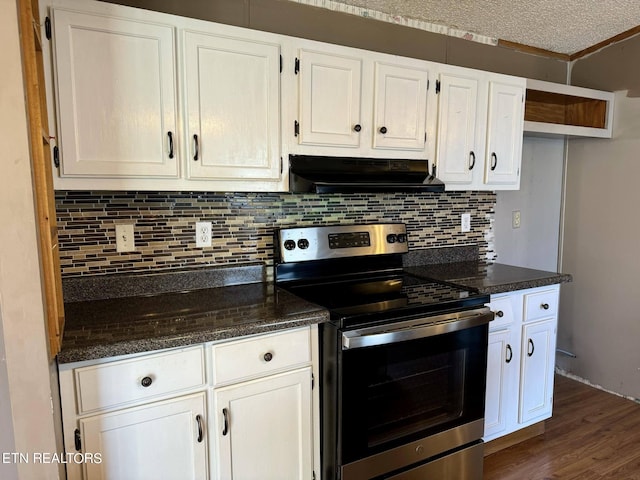 kitchen featuring dark stone countertops, white cabinets, a textured ceiling, stainless steel electric range oven, and dark hardwood / wood-style flooring