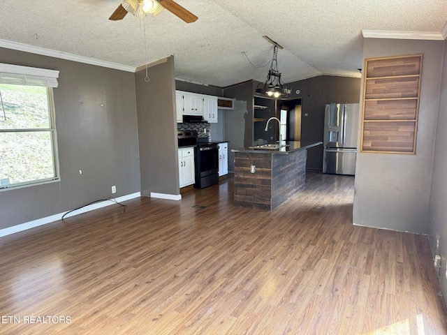 kitchen featuring a center island with sink, appliances with stainless steel finishes, dark hardwood / wood-style floors, and white cabinets