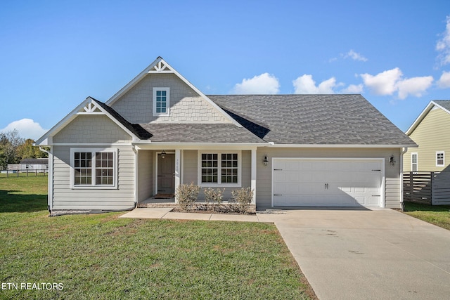 view of front of home featuring a front yard and a garage