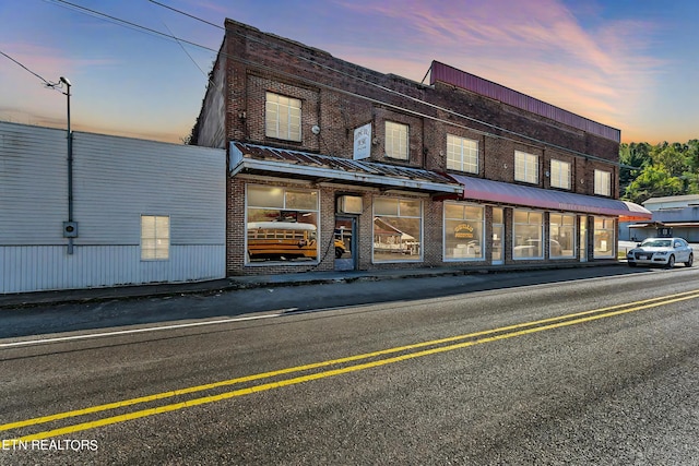 view of outdoor building at dusk