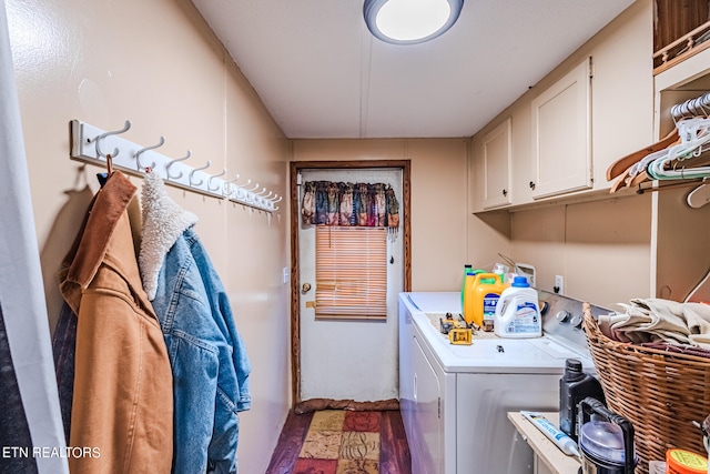 washroom with cabinets and washing machine and dryer