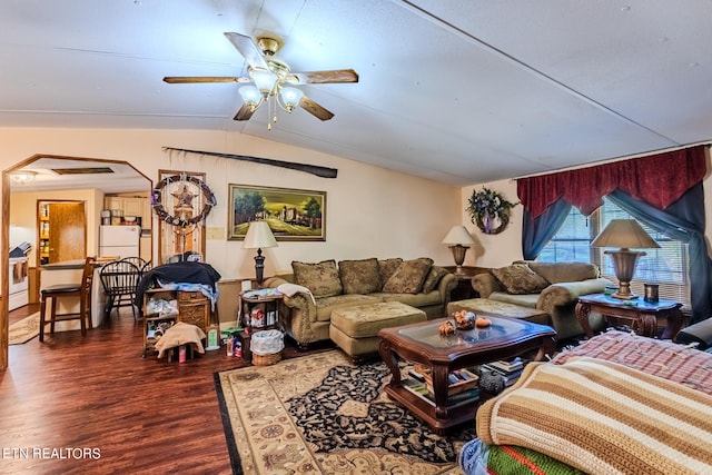 living room with ceiling fan, dark wood-type flooring, and vaulted ceiling