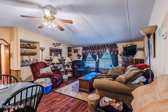 living room featuring lofted ceiling, hardwood / wood-style flooring, and ceiling fan