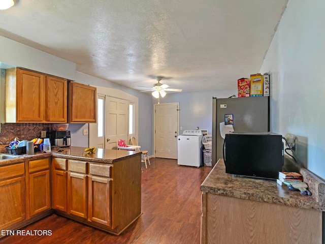 kitchen featuring washer / clothes dryer, a textured ceiling, ceiling fan, decorative backsplash, and dark hardwood / wood-style floors