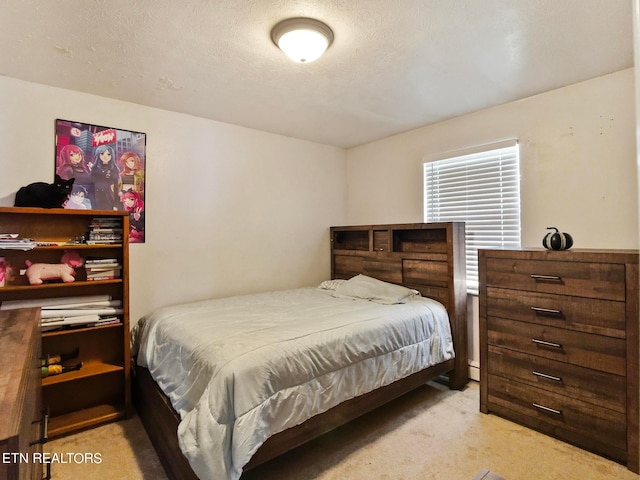 carpeted bedroom featuring a textured ceiling