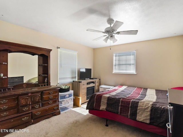 bedroom with light colored carpet and ceiling fan