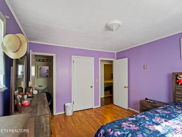 bedroom with hardwood / wood-style flooring and ornamental molding