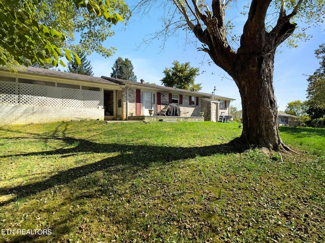 rear view of property with a lawn