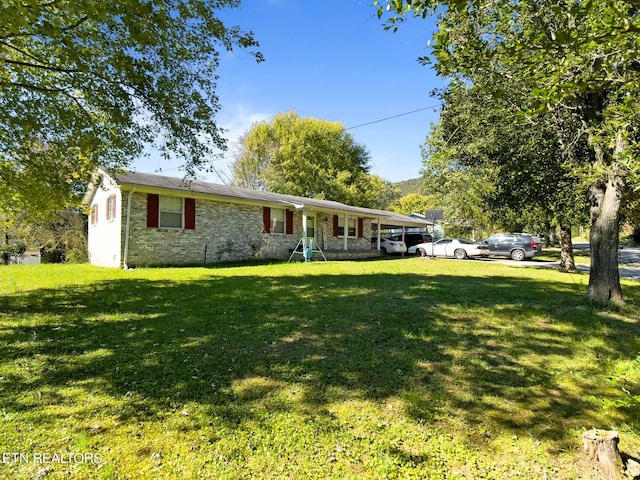 ranch-style home with a front lawn