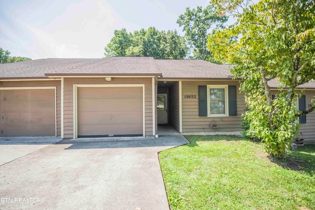 single story home with a front lawn and a garage