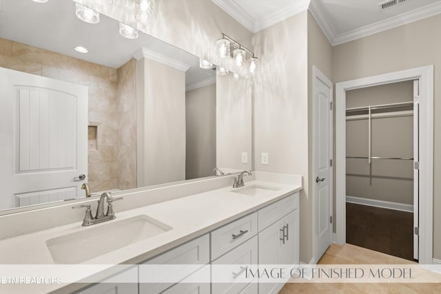 bathroom with vanity, ornamental molding, and tile patterned flooring