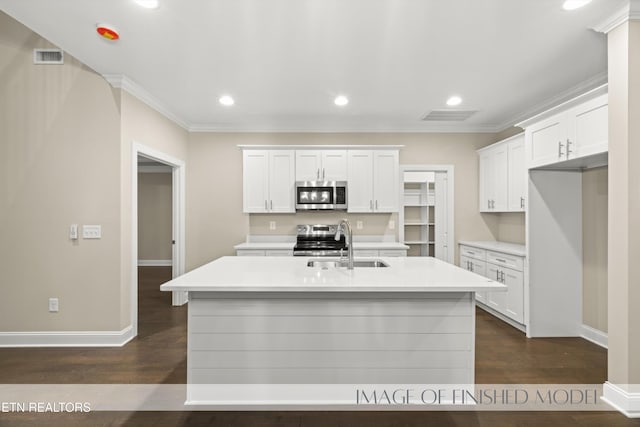 kitchen with white cabinets, a center island with sink, dark hardwood / wood-style flooring, sink, and stainless steel appliances