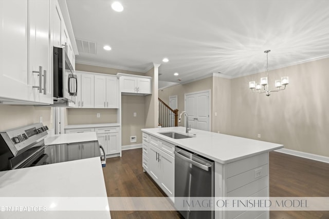 kitchen with an island with sink, sink, pendant lighting, white cabinetry, and appliances with stainless steel finishes