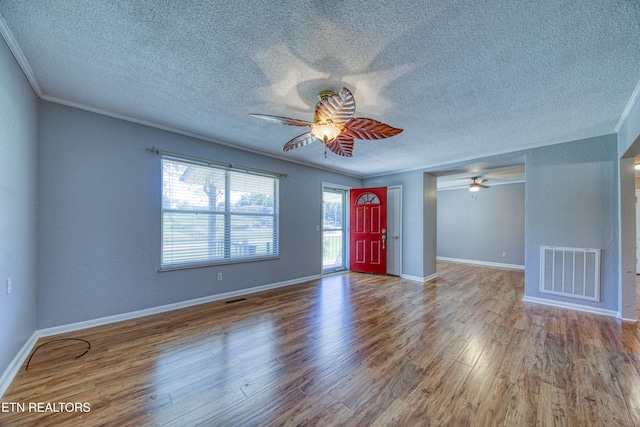 foyer featuring ornamental molding, hardwood / wood-style floors, and ceiling fan