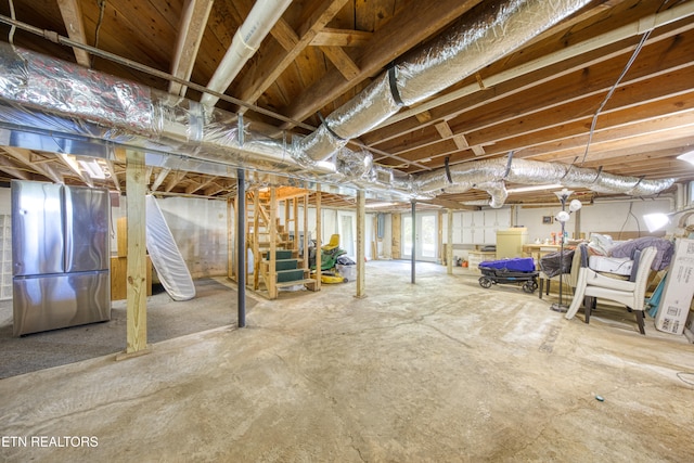 basement with stainless steel fridge