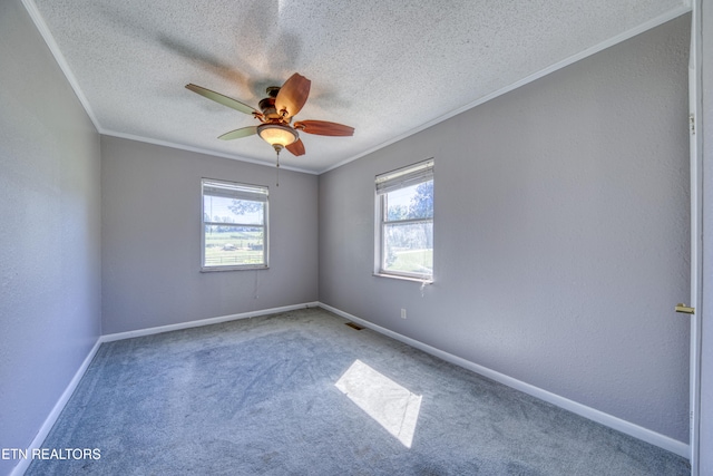 spare room with ornamental molding, a textured ceiling, carpet flooring, and ceiling fan