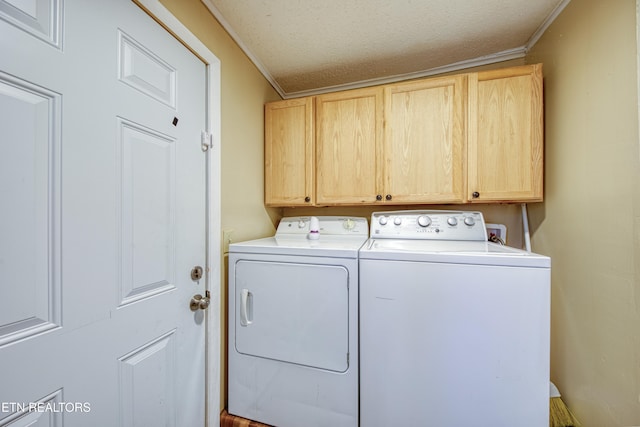 laundry area with crown molding, a textured ceiling, cabinets, and washer and clothes dryer