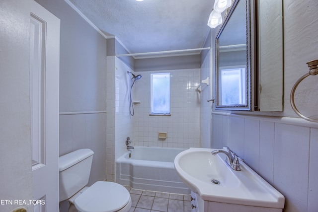 full bathroom with toilet, tile patterned flooring, tiled shower / bath combo, vanity, and a textured ceiling