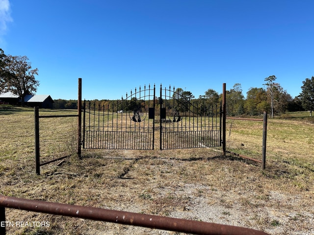 view of gate featuring a rural view