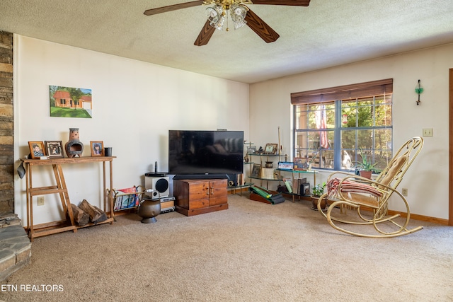 carpeted living room featuring a textured ceiling and ceiling fan