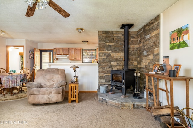 carpeted living room with a textured ceiling and ceiling fan