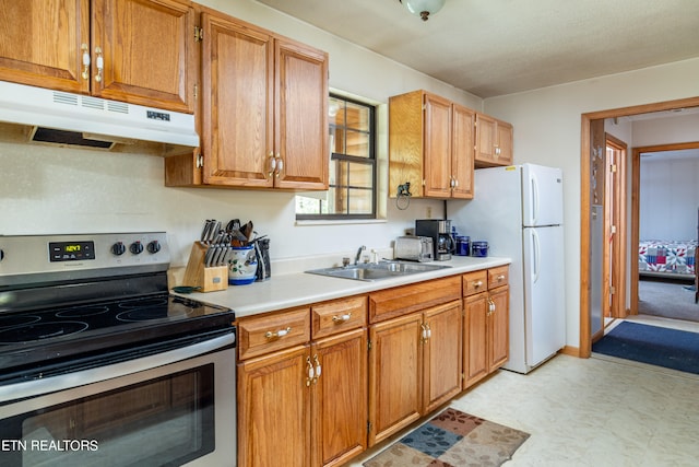 kitchen with stainless steel range with electric stovetop, sink, and white refrigerator