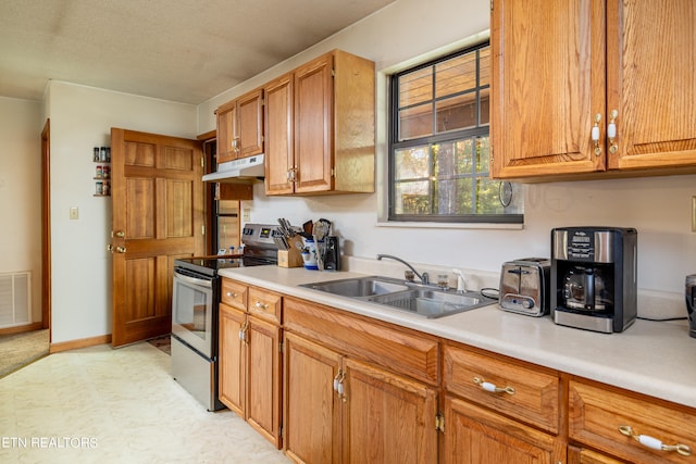 kitchen featuring stainless steel electric stove and sink