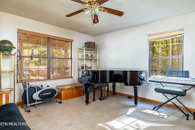 misc room featuring light carpet, a textured ceiling, and ceiling fan