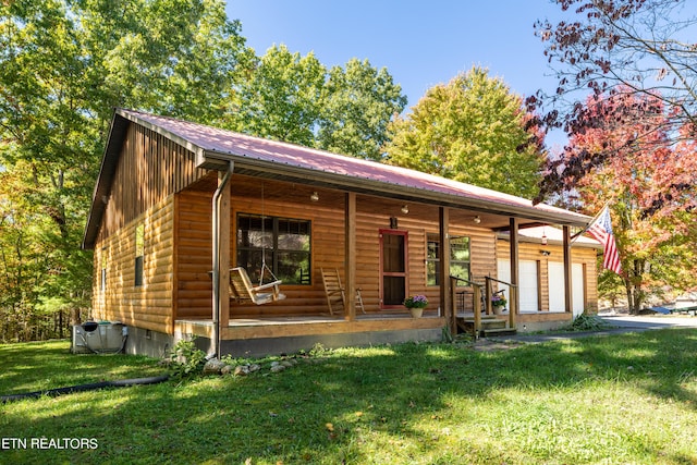 back of property featuring a porch and a lawn