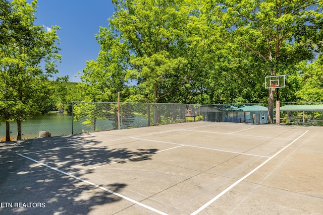 view of basketball court with a water view