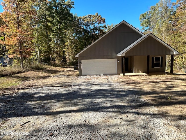 view of front property with a porch and a garage